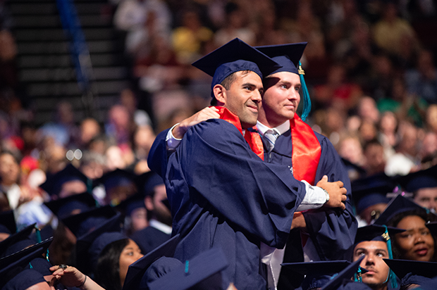 Two male student celebrate at Commencement